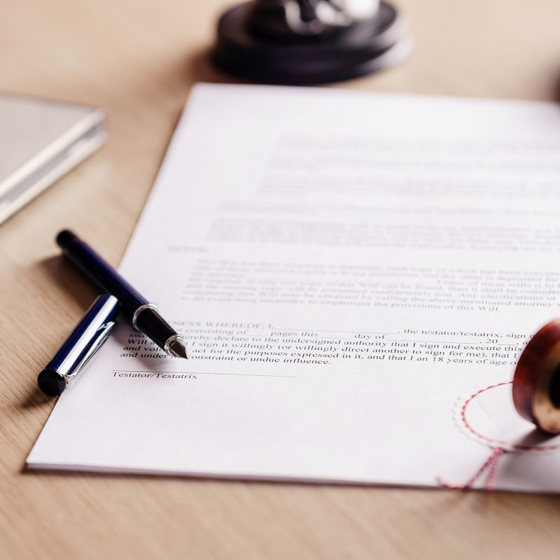 Notary pen lying on testament. Notary public working accesories